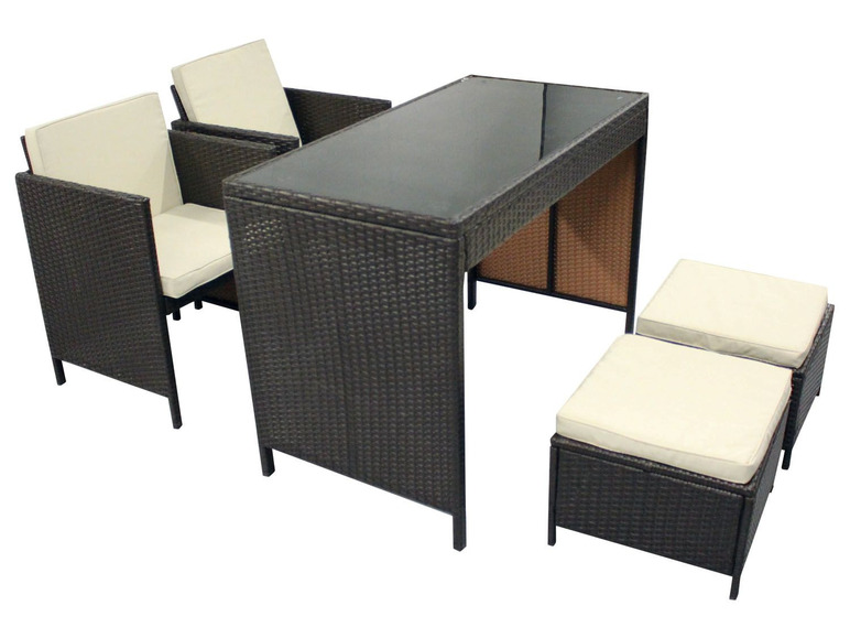 Ensemble de mobilier de jardin en rotin avec table en verre et coussins.