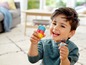 Un garçon joue avec des briques LEGO DUPLO et une figurine.