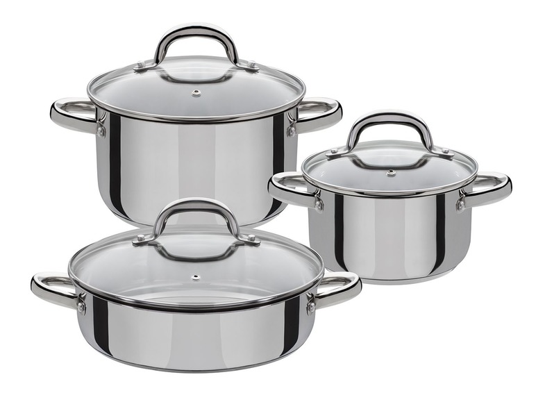 Un ensemble de trois casseroles en acier inoxydable avec couvercles en verre.