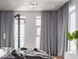 Une chambre moderne avec des rideaux gris, un grand lit et un luminaire élégant.