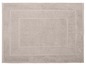 Tapis de bain beige avec un bord détaillé.