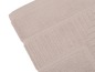Une partie d'une serviette de bain en éponge beige.