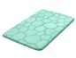 Un tapis de bain vert clair avec un motif en grille.
