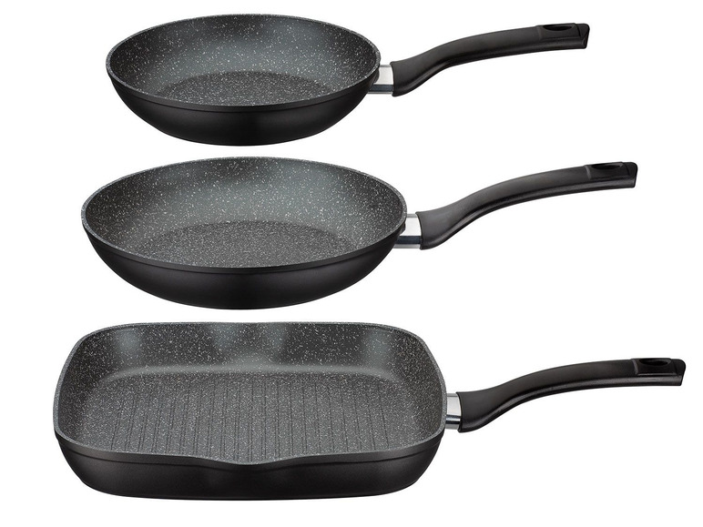 Trois poêles avec un fini marbré : une poêle ronde pour griller et deux poêles rondes pour frire.