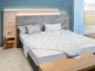 Une couette blanche Beco sur un lit avec une tête de lit en bois.