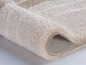 Tapis beige avec une texture brossée.