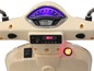 Un scooter beige avec un compteur de vitesse, un affichage numérique et des commandes.