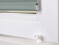 Un store gris sur une fenêtre blanche