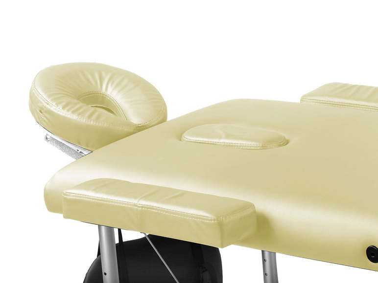 Table de massage beige avec appui-tête et accoudoirs.
