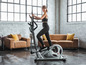 Une femme utilise un crosstrainer ELITE E5000 Pro pour faire de l'exercice.