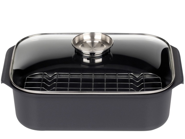 Un plat à rôtir noir avec un couvercle en verre et une grille.