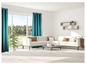 Un canapé d'angle blanc avec des rideaux turquoise dans un salon moderne.