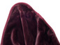 Une partie d'une couverture en peluche de couleur bordeaux.