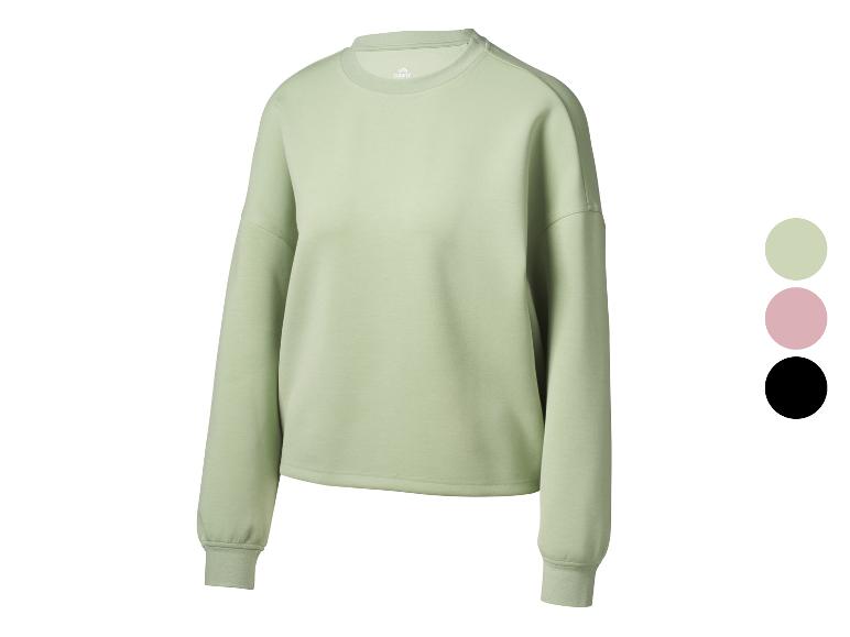 Sweat-shirt femme Crivit vert clair avec col rond et échantillons de couleurs.