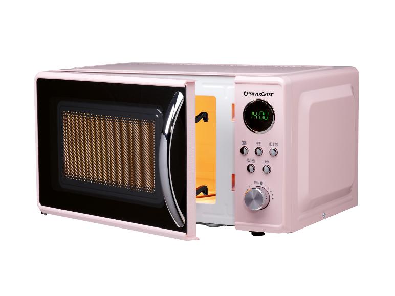 Four à micro-ondes rose rétro SilverCrest avec porte ouverte.