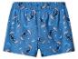 Short de pyjama bleu avec motif de personnages de dessins animés, de lune et d'étoiles.