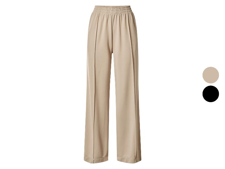 Pantalon large beige pour femme avec taille élastique, également disponible en noir.