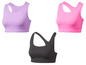 Trois soutiens-gorge de sport en différentes couleurs : violet, rose et noir.