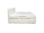 Lit double blanc avec tête de lit et sommier rembourrés, matelas et surmatelas inclus.