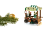 Étal de vente de sapins de Noël avec figurines miniatures, sapins et liste de prix, à côté d'une boule dorée scintillante et d'une branche de pin.