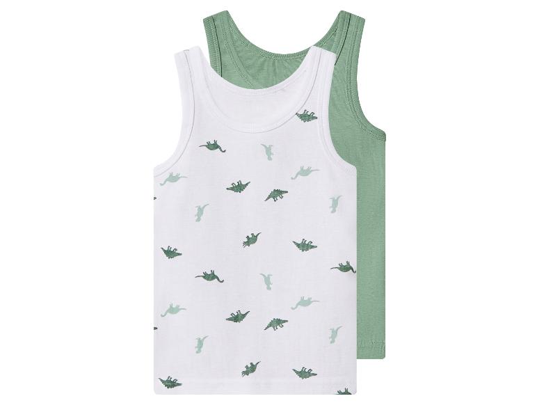 Deux débardeurs pour enfants, un blanc avec des imprimés de dinosaures verts et un vert uni.