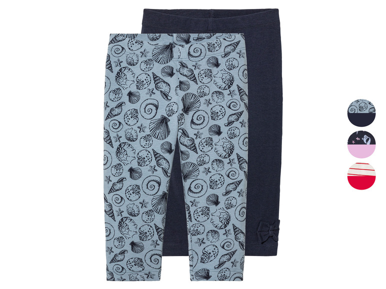 Deux leggings pour filles, l'un à imprimé coquillages et l'autre uni bleu foncé.