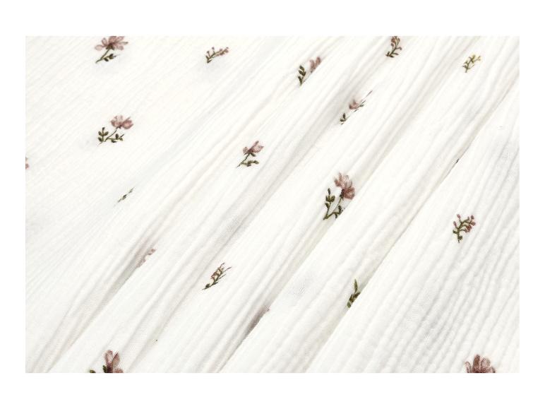 Tissu blanc avec un motif délicat de petites fleurs roses.