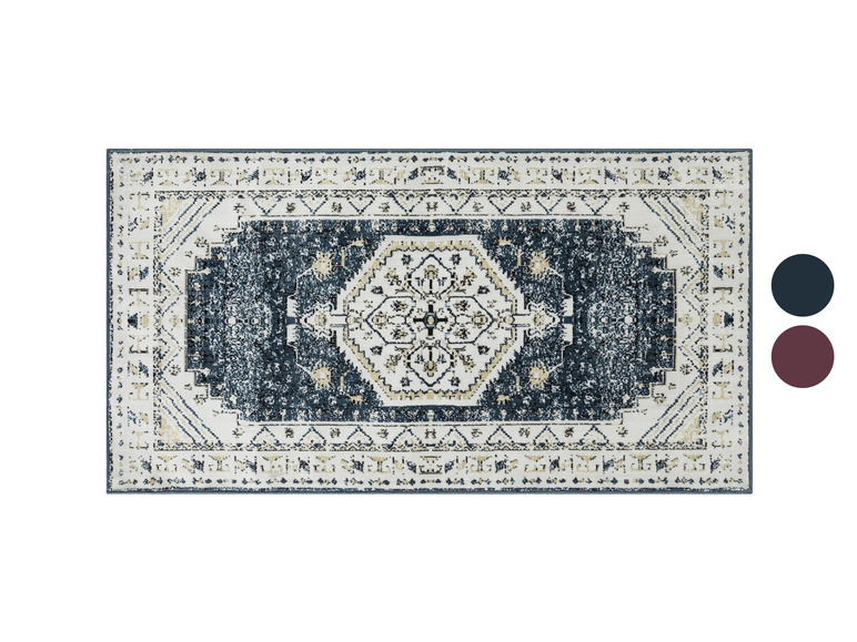 Un tapis bleu foncé avec un motif géométrique blanc.