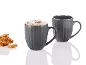 Deux tasses grises avec du café et une pile de biscuits aux cacahuètes.