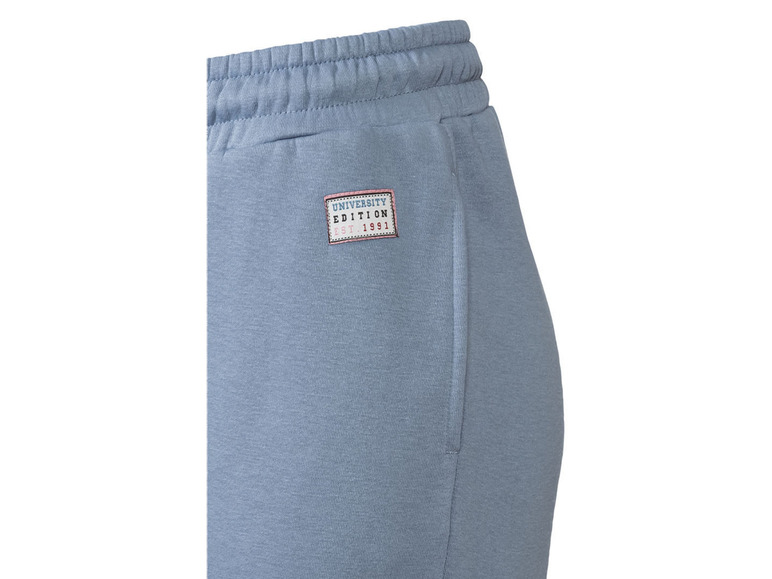Pantalon de jogging bleu avec l'étiquette 'University Edition 1991'.
