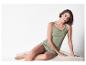 Modèle portant un débardeur vert olive et un short rayé.