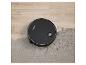 Robot aspirateur noir nettoyant un tapis gris et un sol en bois avec de la saleté.
