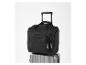 Sac de voyage noir à roulettes, posé sur une valise grise.