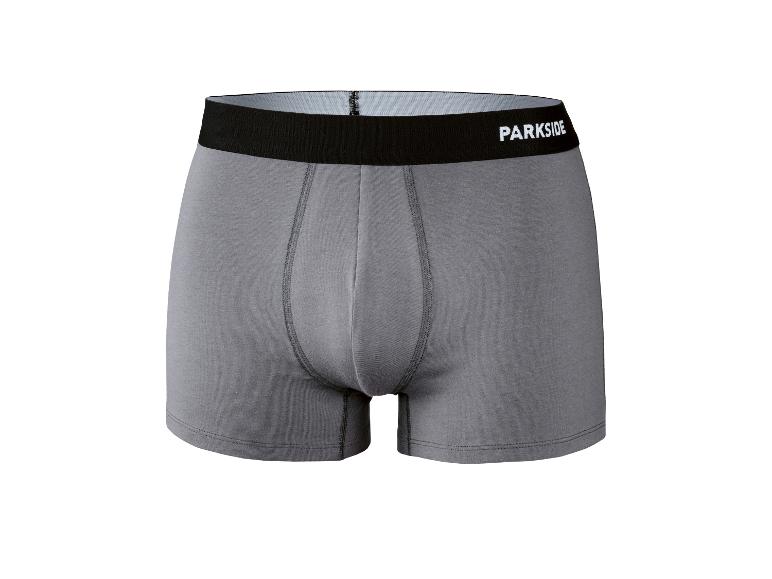 Caleçon gris avec ceinture élastique noire et texte blanc.