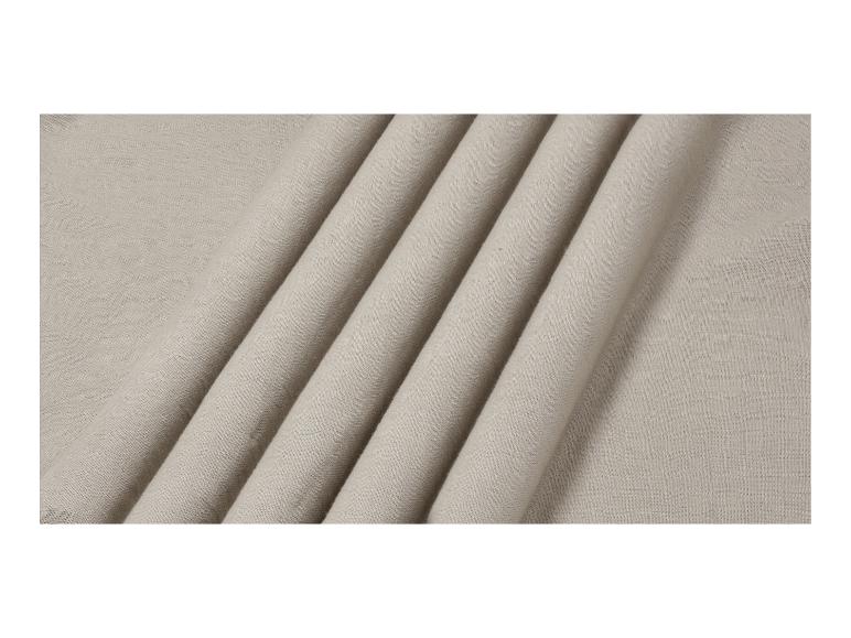 Tissu en lin beige clair avec des plis doux.