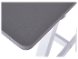 Bureau gris foncé avec pieds blancs.