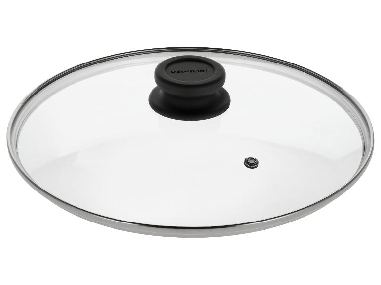 Couvercle en verre pour casserole avec poignée noire et bord métallique.