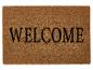 Un paillasson d'accueil avec l'inscription 'WELCOME'.