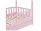 Lit pour enfant rose avec barrières et deux tiroirs.