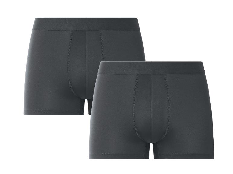 Deux boxers gris foncé pour hommes, posés sur un fond blanc.