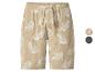Short en lin beige avec motif de feuilles blanches et cordon de serrage réglable.