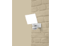 Projecteur LED extérieur avec détecteur de mouvement monté sur un mur en briques.