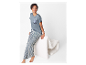 Modèle portant un pyjama rayé avec un t-shirt à poche en satin.