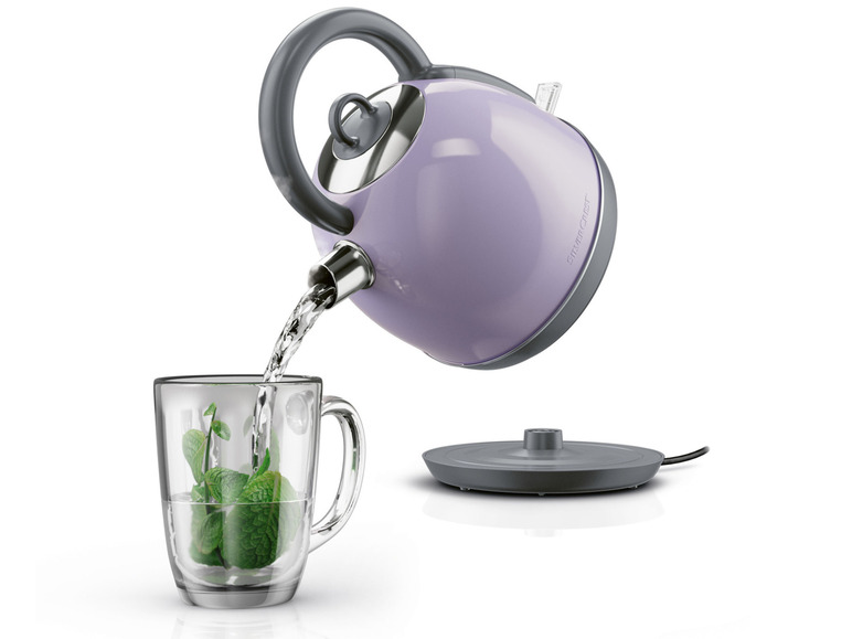 Une bouilloire violette Silvercrest verse de l'eau dans une tasse