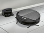 Un aspirateur robot Silvercrest noir avec station de charge.
