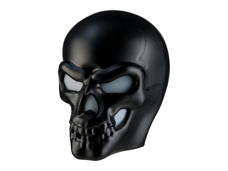 Masque de crâne noir avec yeux et nez lumineux.