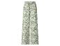 Pantalon large vert avec motif floral blanc.