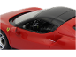 Gros plan d'une voiture de sport rouge miniature avec un toit noir.