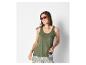 Femme en débardeur vert et pantalon à motifs, portant des lunettes de soleil.