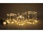 Trois boîtes cadeaux illuminées avec des décorations de Noël